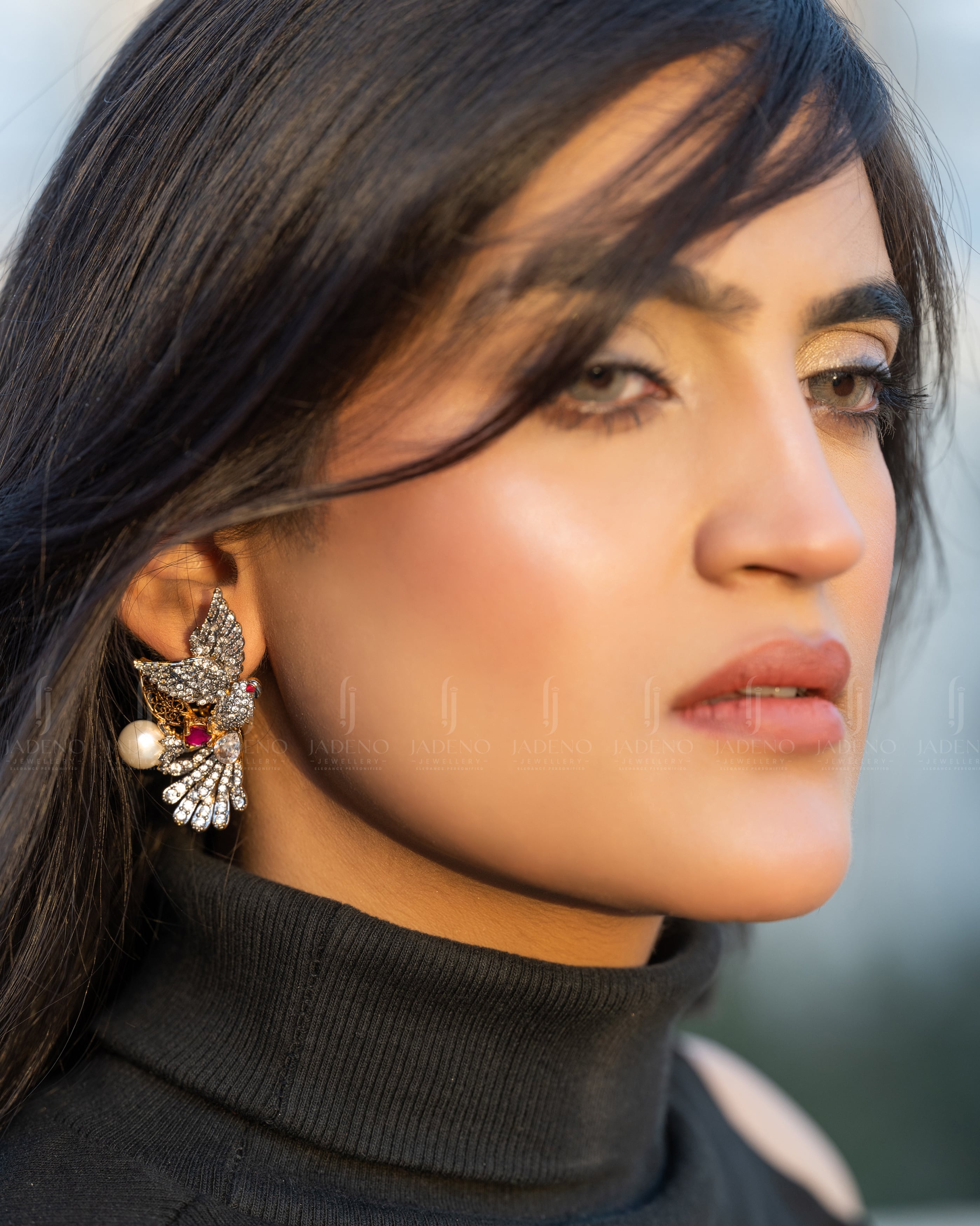 "Model wearing Fanciable Silver Laser Rhodium Studs with gemstones, pearls, and golden accents. Perfect for formal and festive occasions. Available at JADENO"