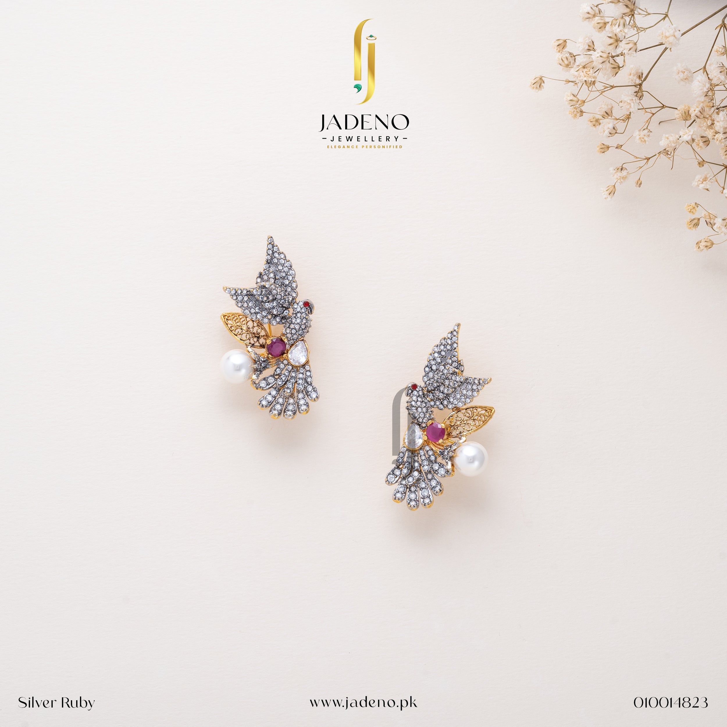 "Elegant Silver Laser Rhodium Studs with gemstones, pearls, and golden accents. Perfect for formal and festive occasions. Available at JADENO"