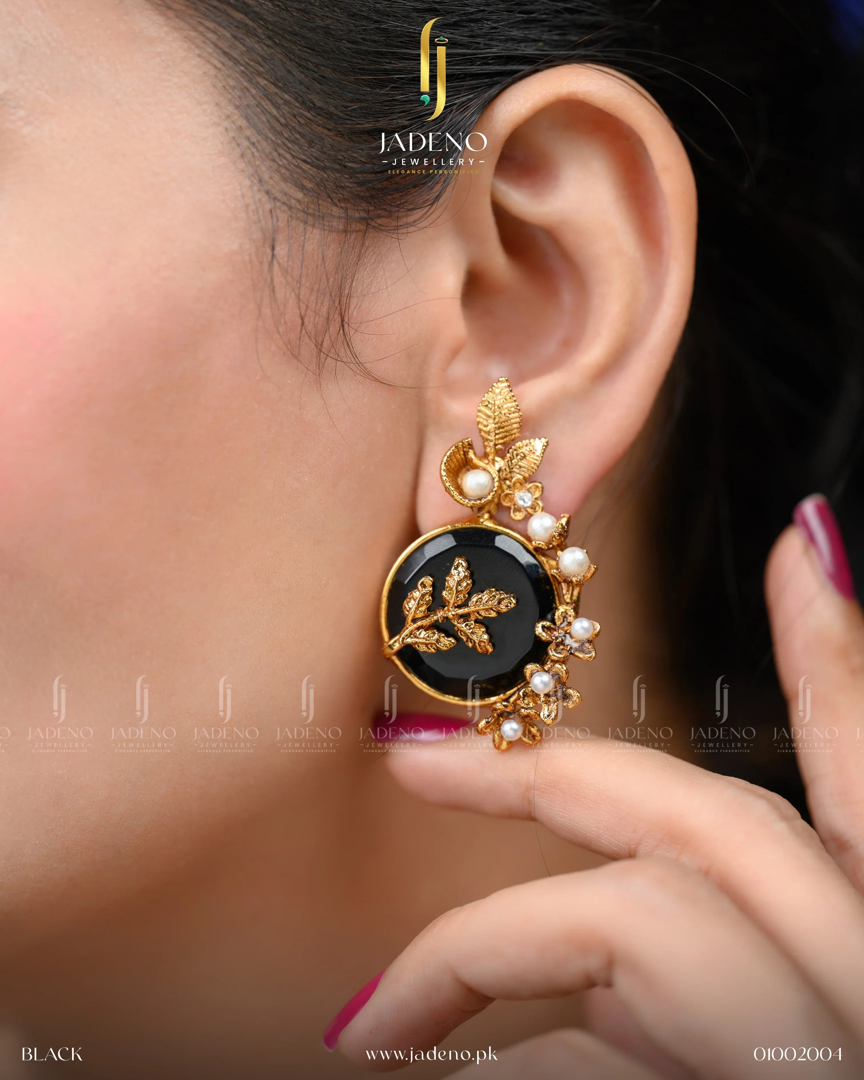 "Earrings for women featuring black stone and pearl accents, worn on ear"