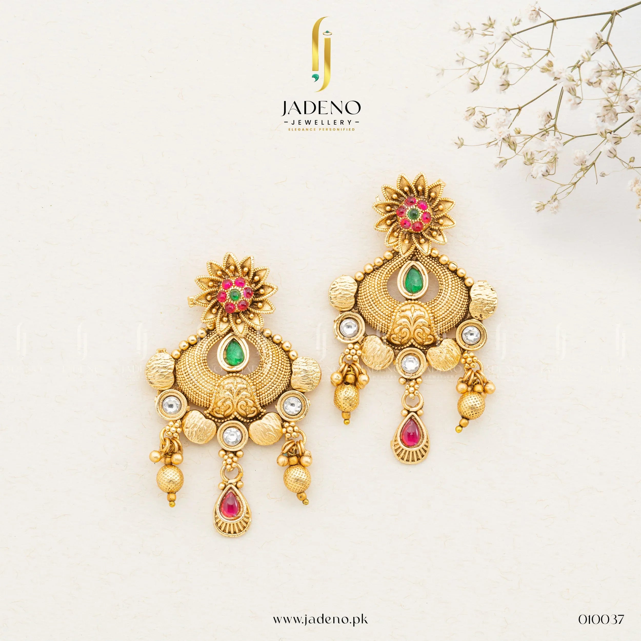 "Elegant gold Rajwadi earrings with colorful gemstones, including ruby and green, adorned with intricate gold detailing. Available at JADENO"