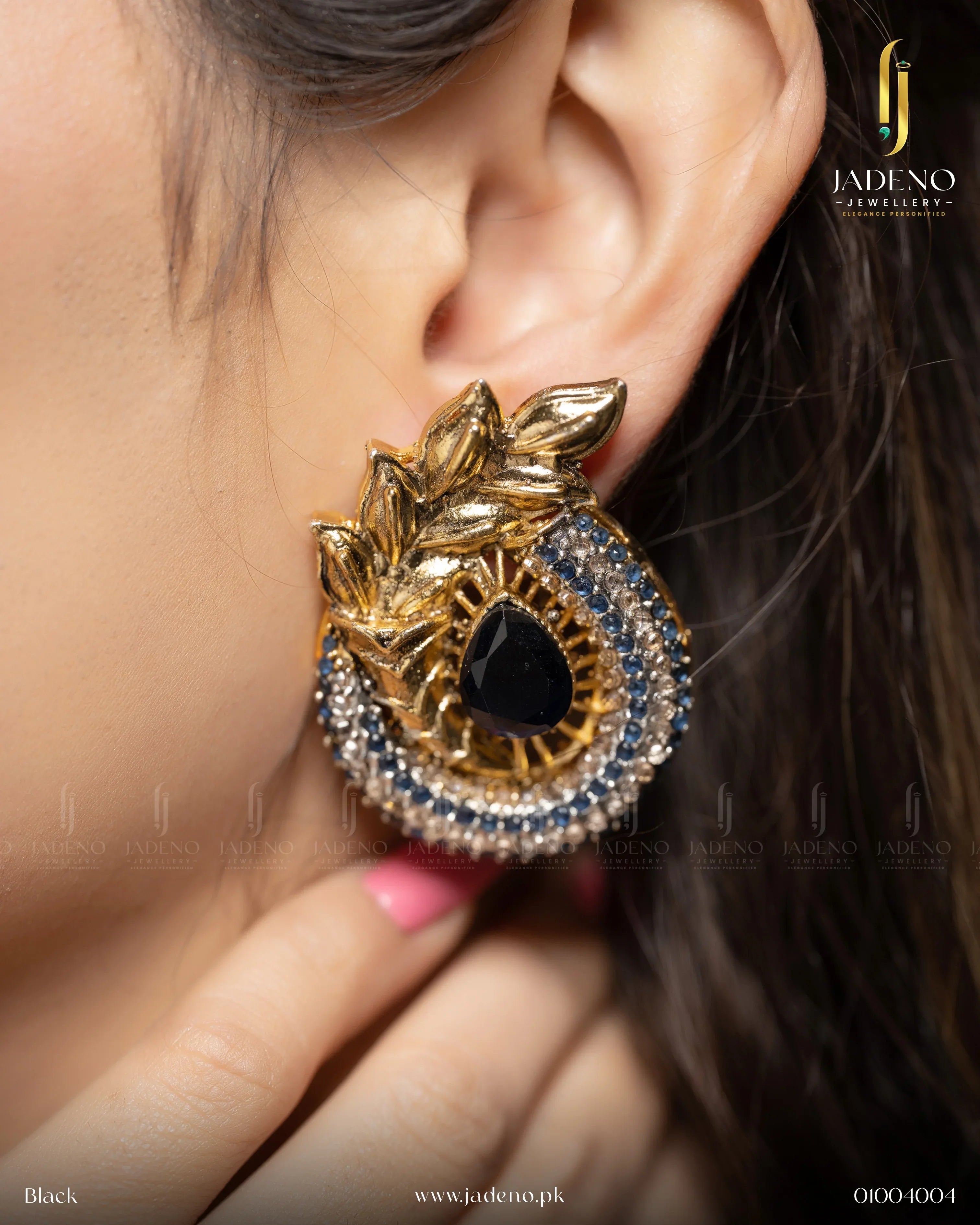 "Elegant blue-colored Ancient Leaf earrings with gold detailing and sparkling gemstones, worn on the ear. Perfect for formal occasions. Available at JADENO"