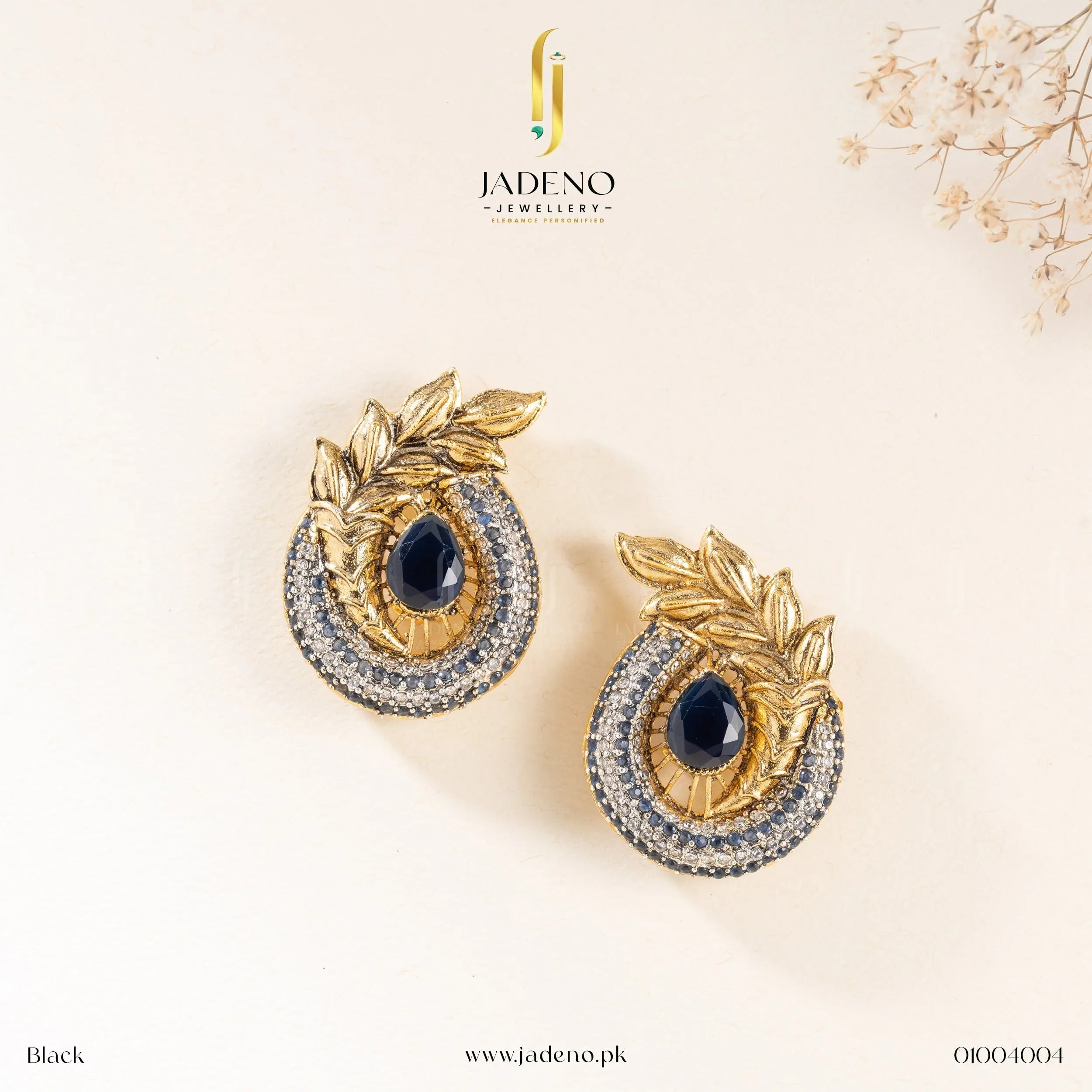 "Elegant blue-colored Ancient Leaf earrings with gold detailing, featuring a teardrop center stone and sparkling gemstones. Available at JADENO"