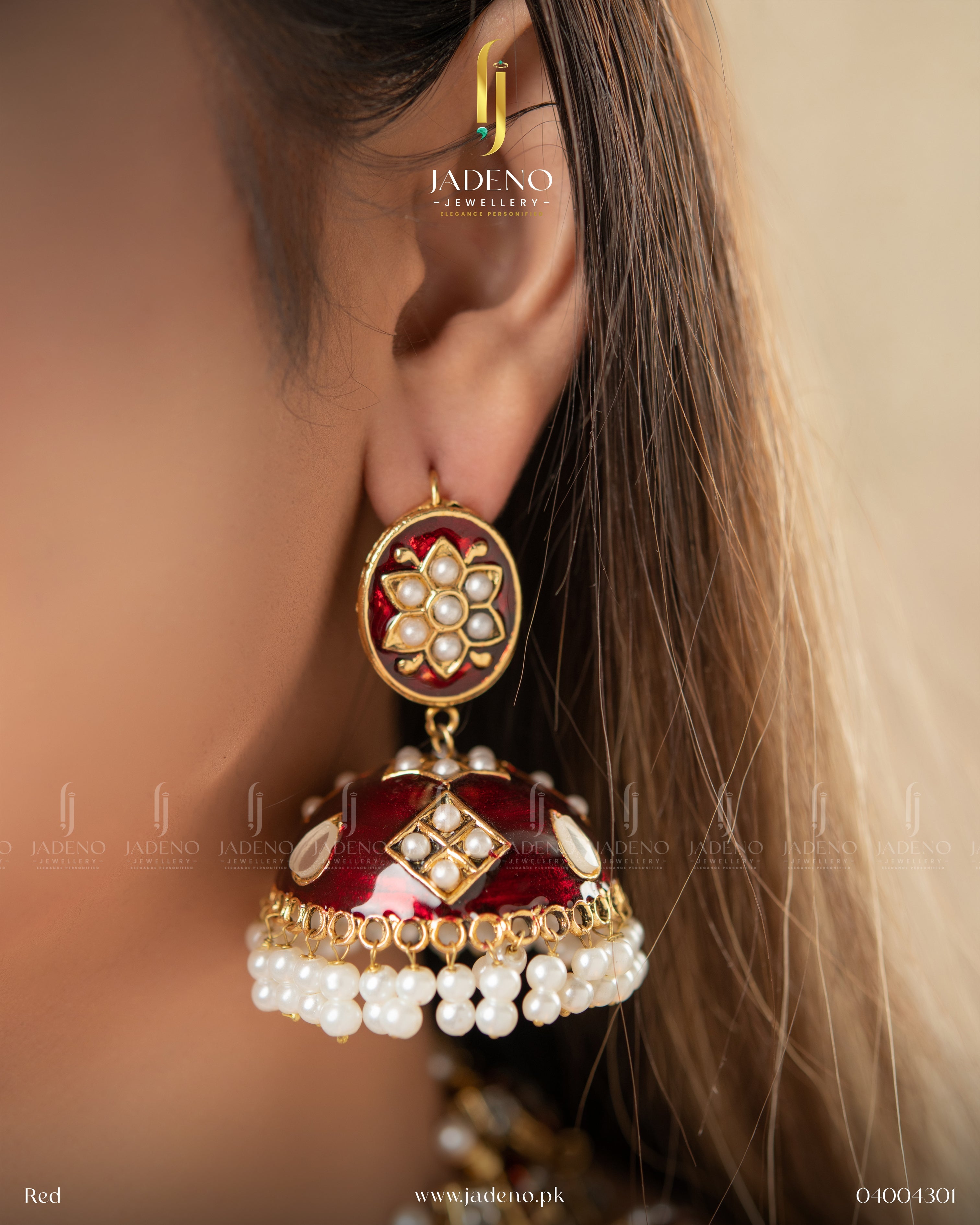 "Artificial jhumka earrings design with red kundan stones worn on model"