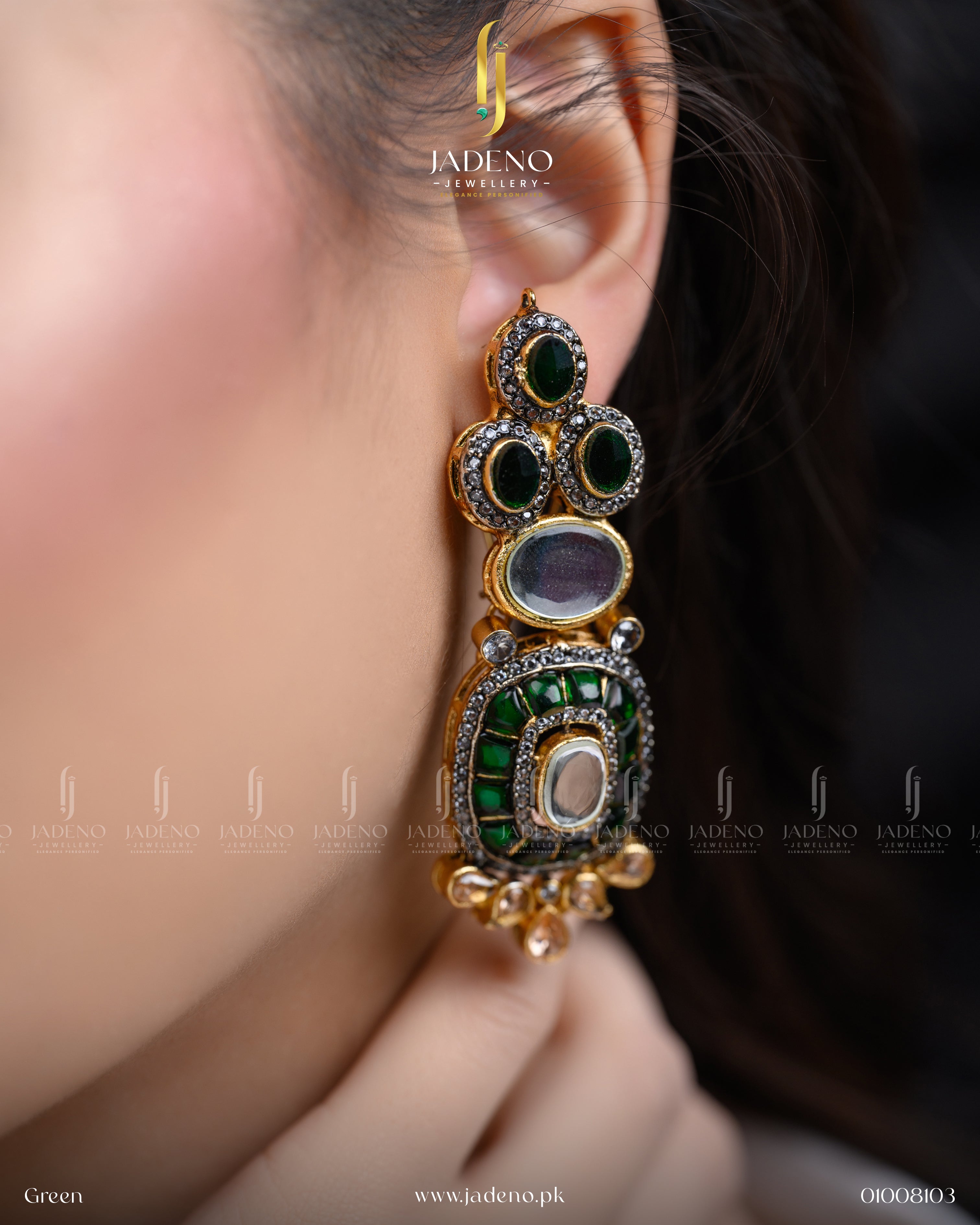 "A woman wearing green stone cut earrings with gold detailing"