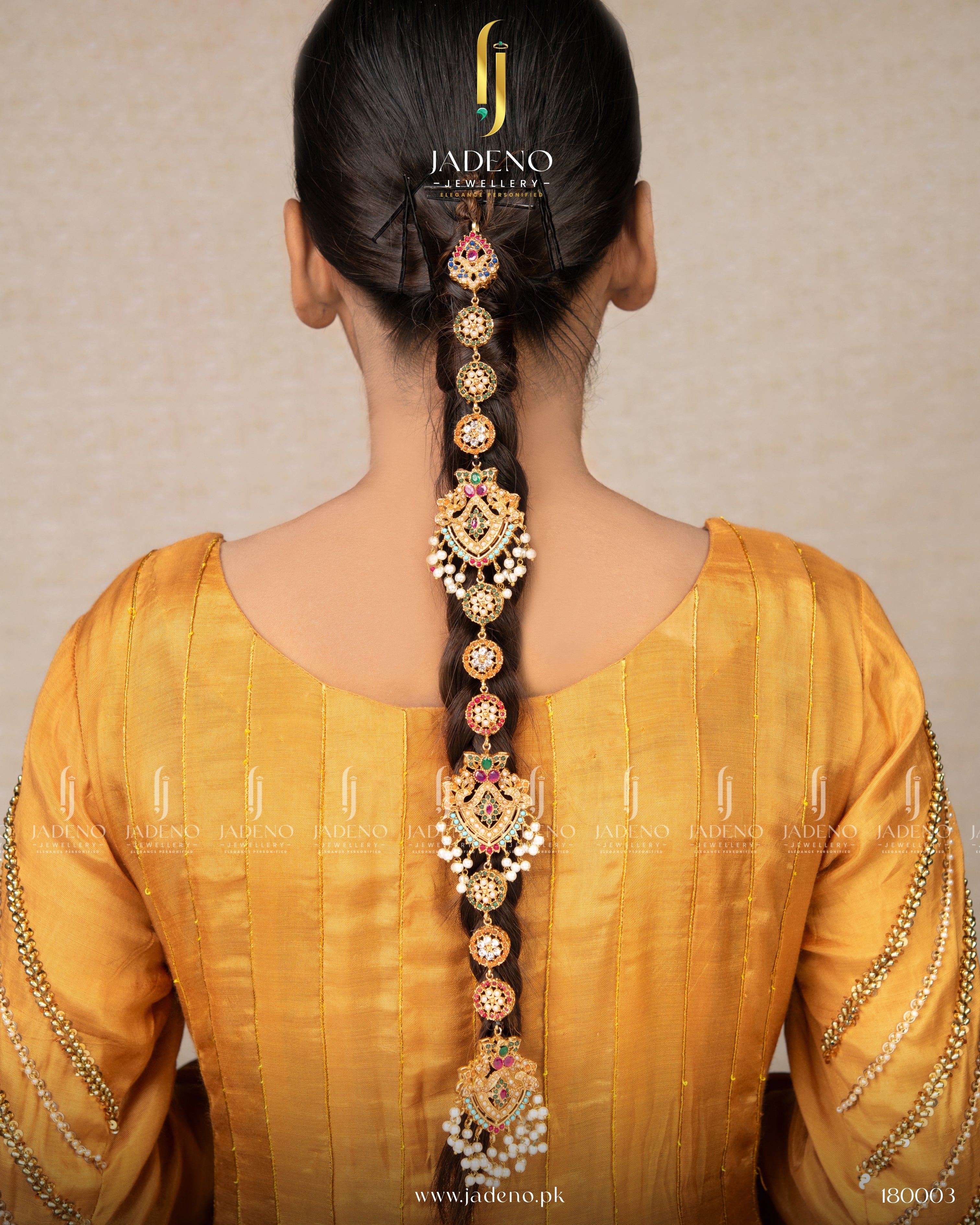 "Handmade nauratan paranda with multicolor stones styled on braided hair"
