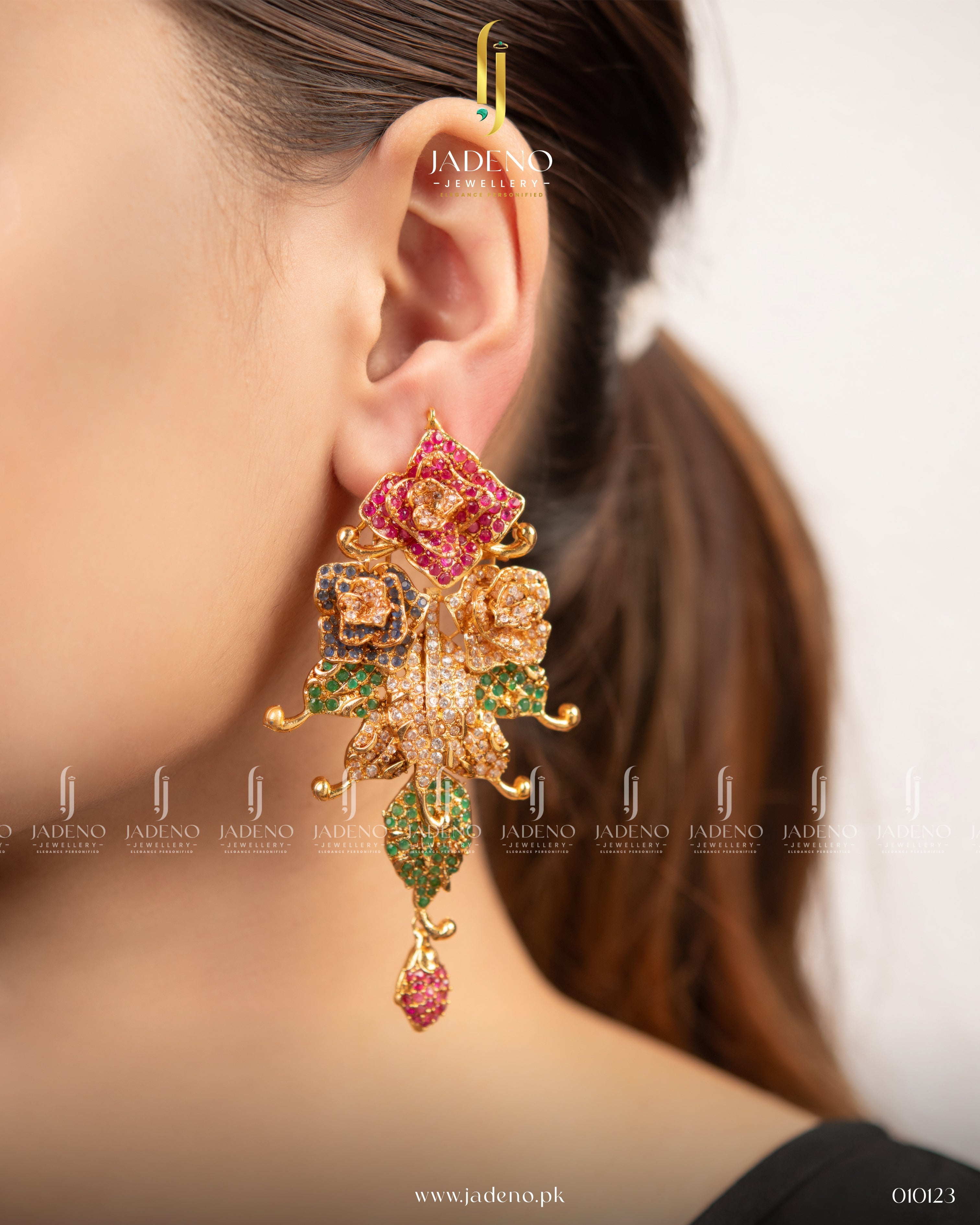 "Multi colored floral pasha earrings worn on ear with green, pink, and gold detailing"