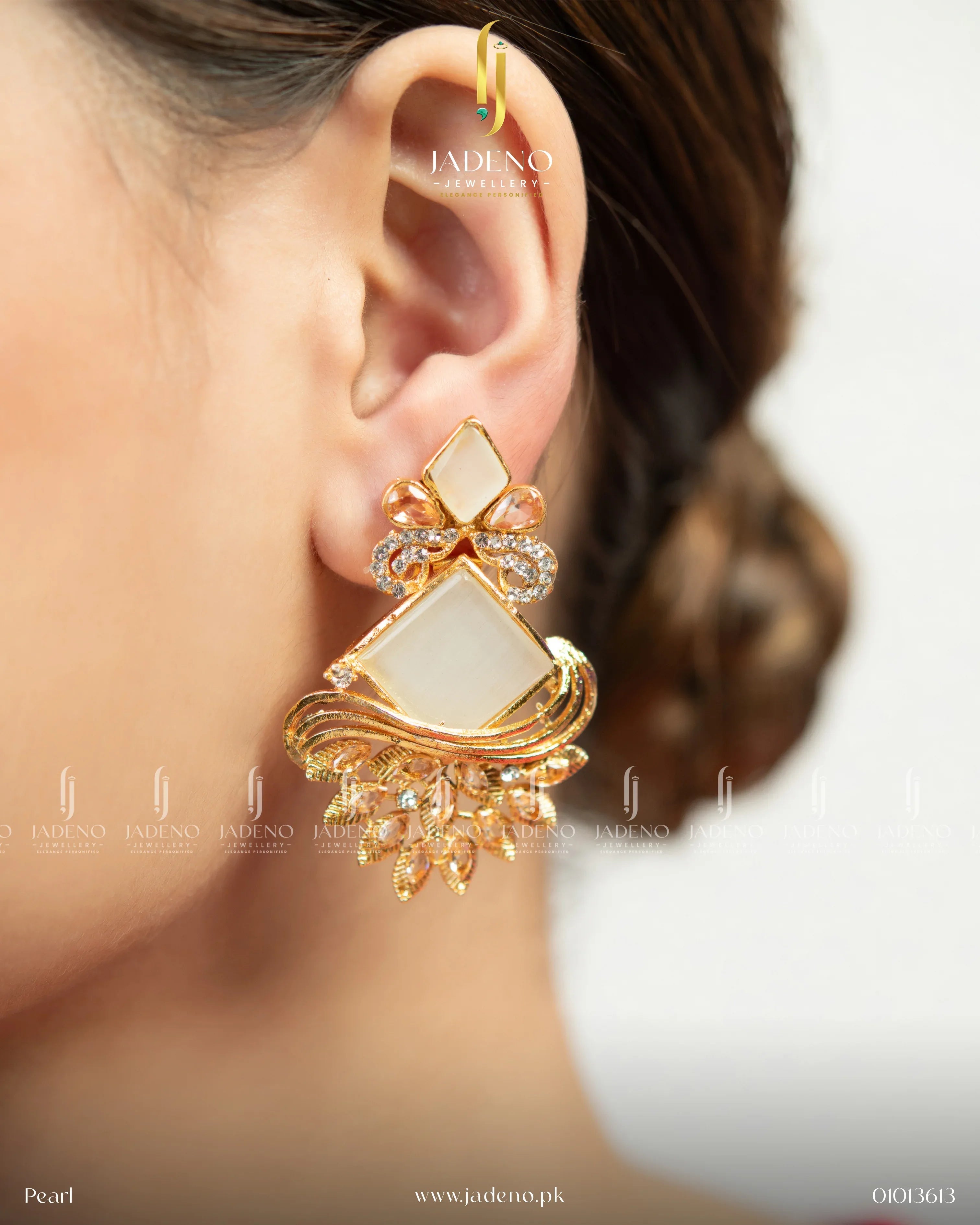 "Bohemia dangle handmade earrings for women with white stone and gold-tone detailing, pair displayed in hand"