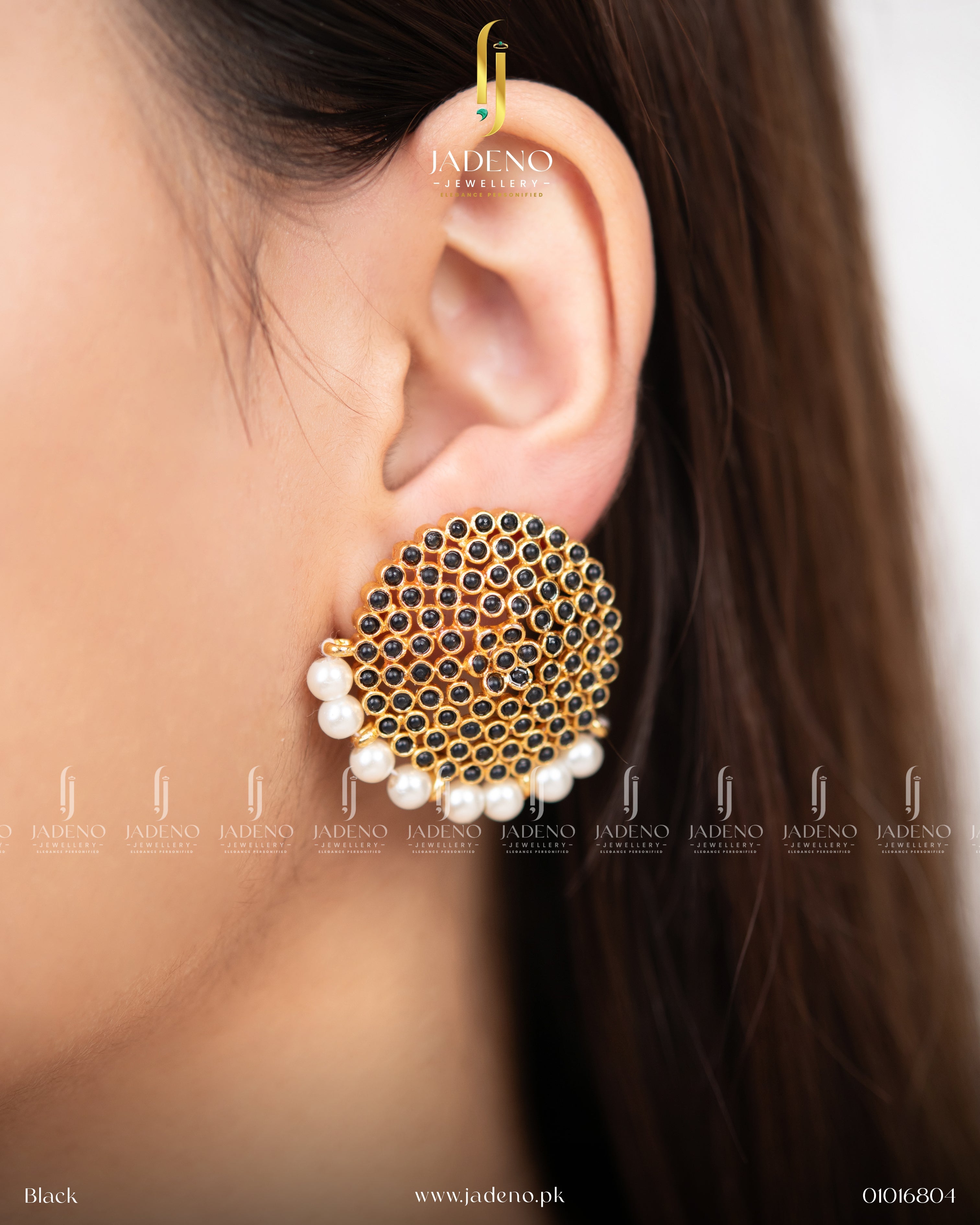 "Artificial stone stud earrings in black color with pearl detailing worn on model"