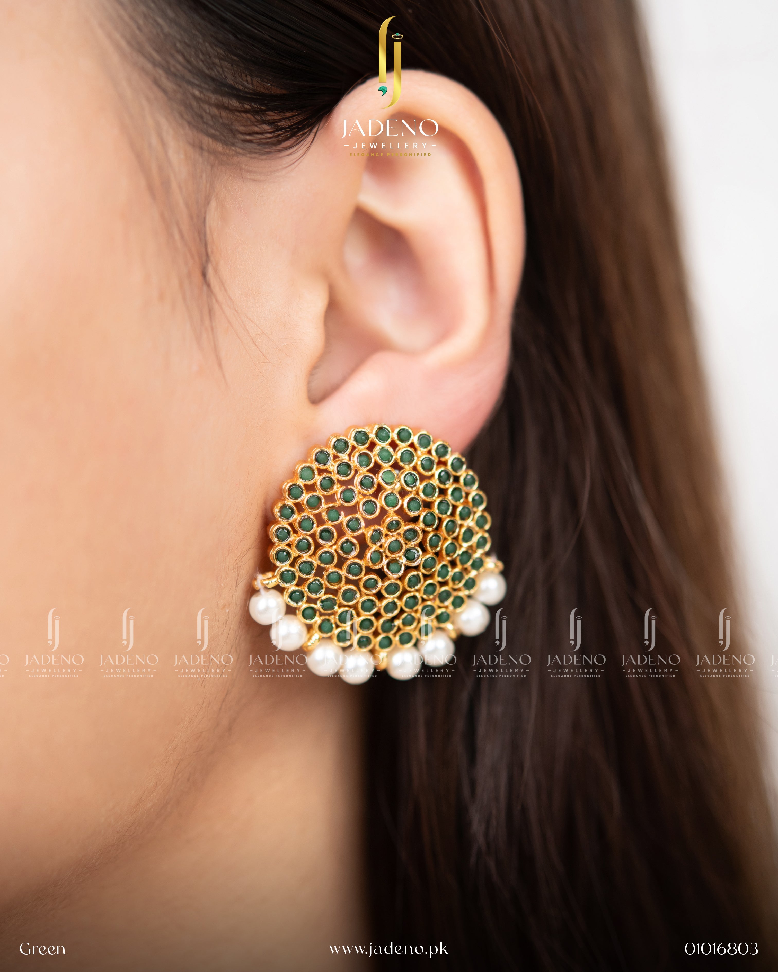 "Woman wearing round green stone earrings accented with pearl drops"