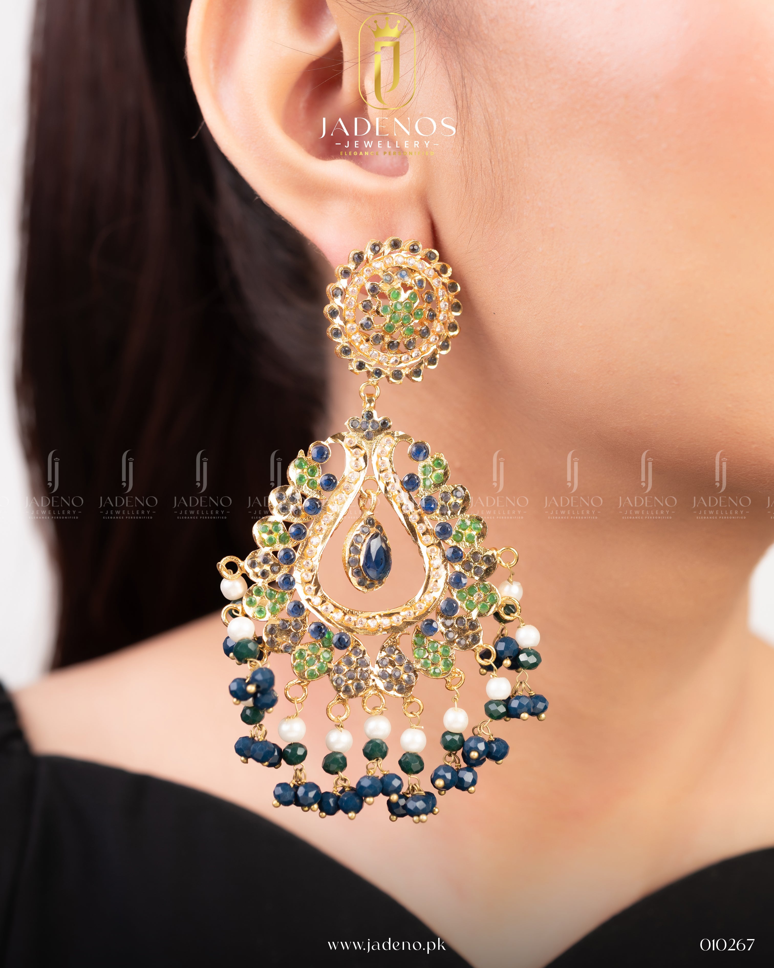 The Sunehri Sitara Earrings featuring a stunning blend of green, blue, and white stones, elegantly designed with a drop style for a bold, traditional look.