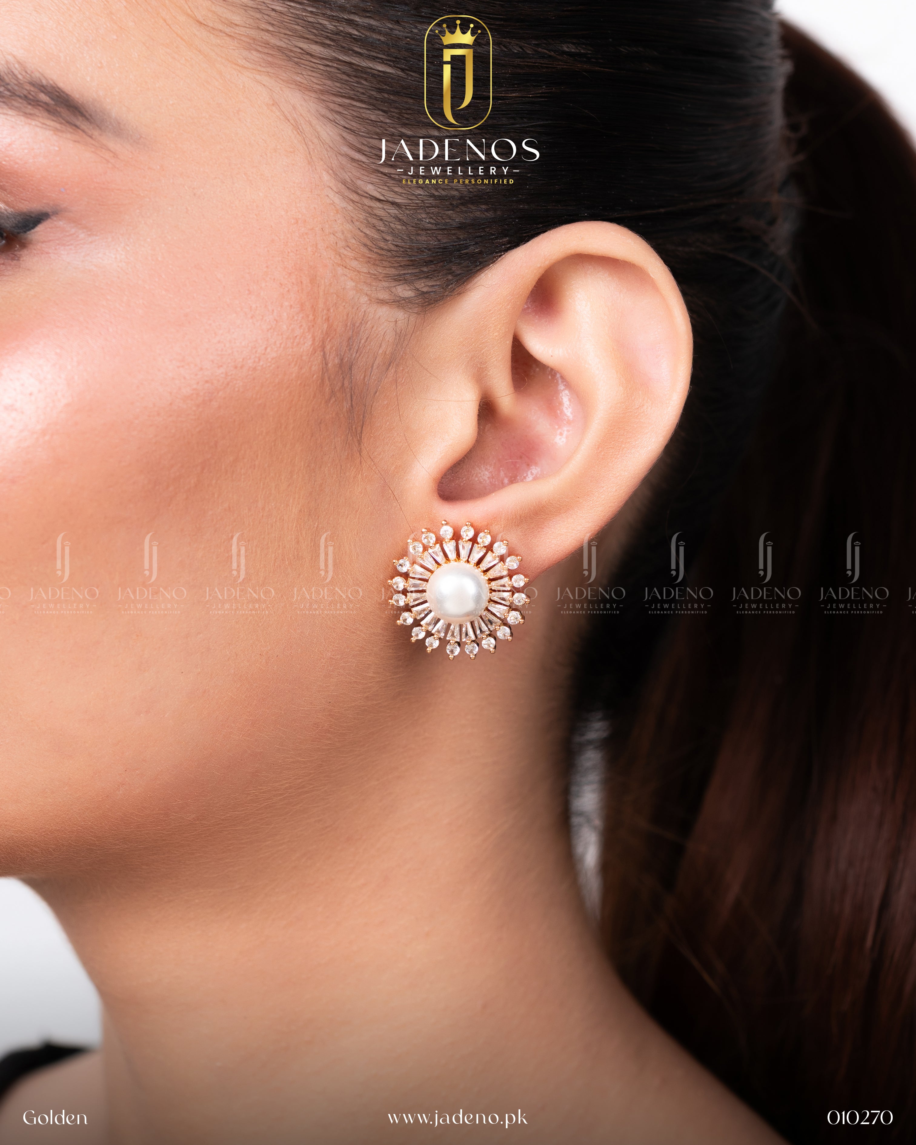 A close-up of The Bloomy Studs in golden, featuring a central pearl encircled by clear crystal stones in a sunburst pattern, worn on a model's ear.