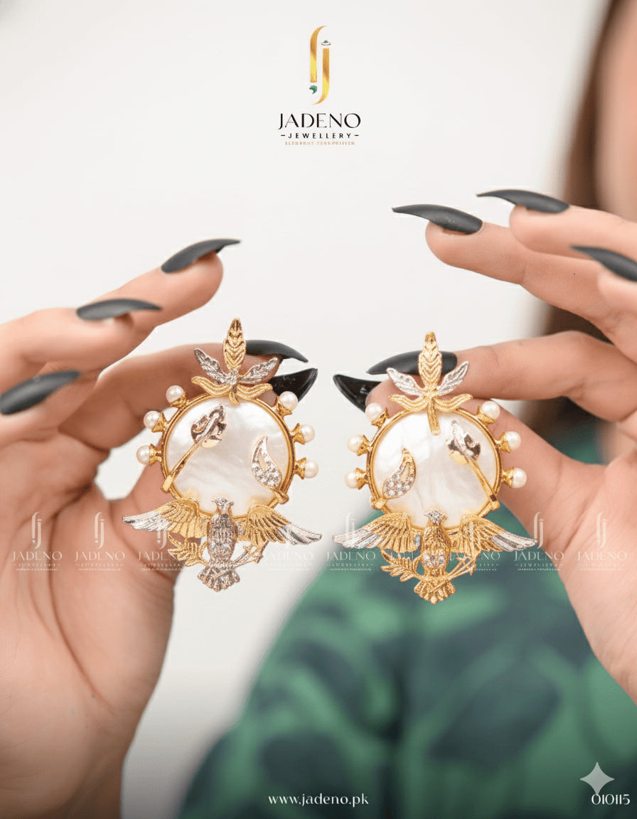 Victorian White Stone Earrings with gold detailing, pearl accents and eagle motif, held in hands for display.